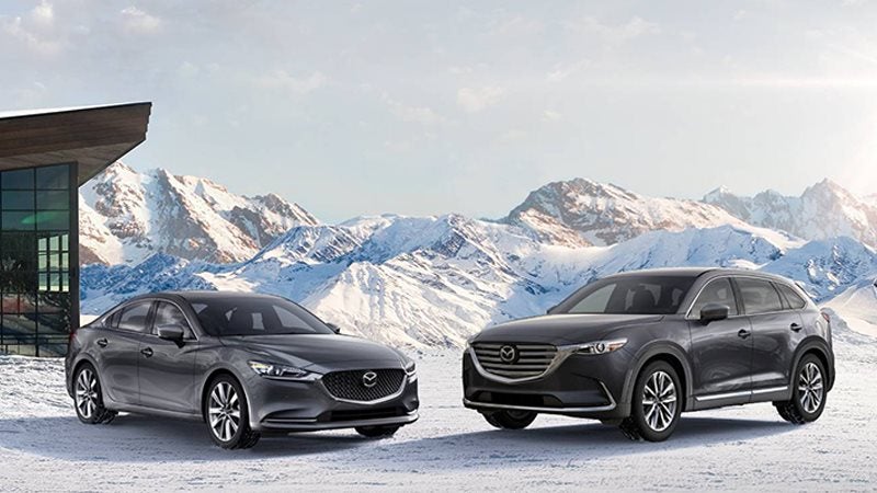 Lineup of Mazda vehicles with mountains in background